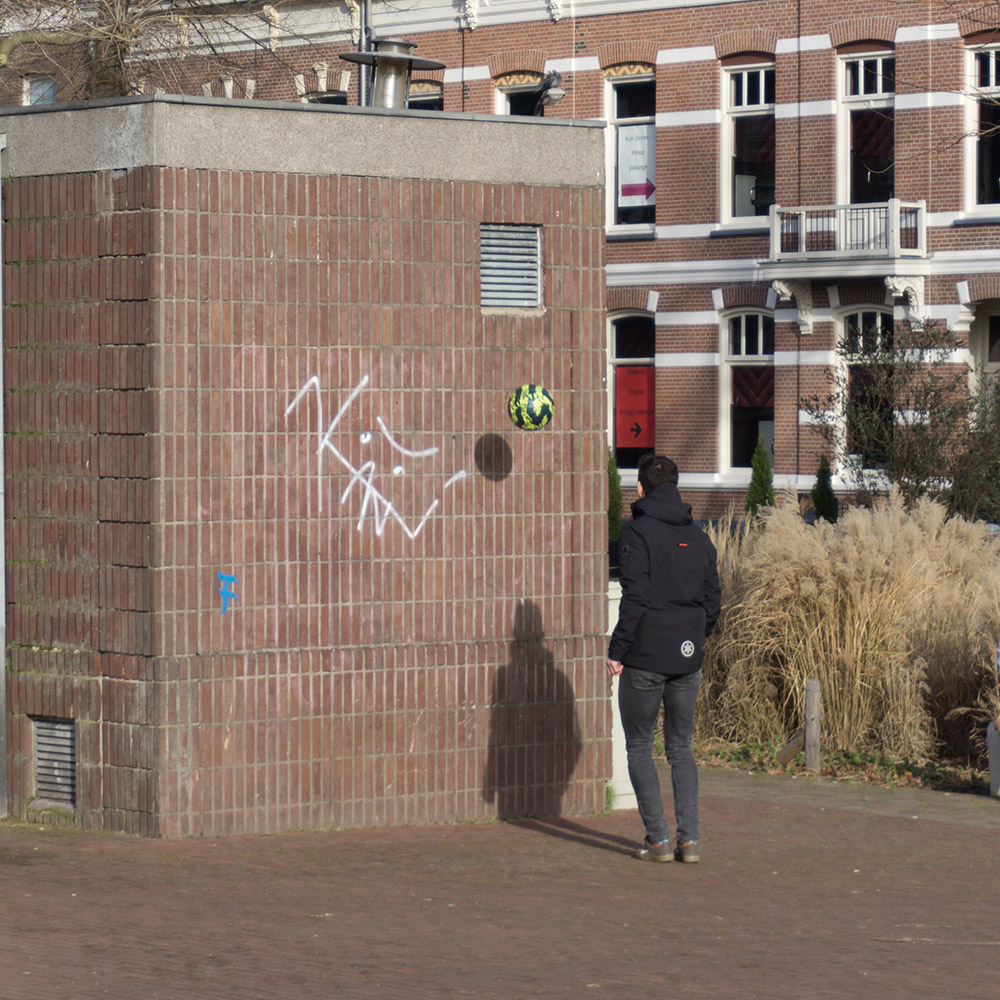 Playing with ball against wall